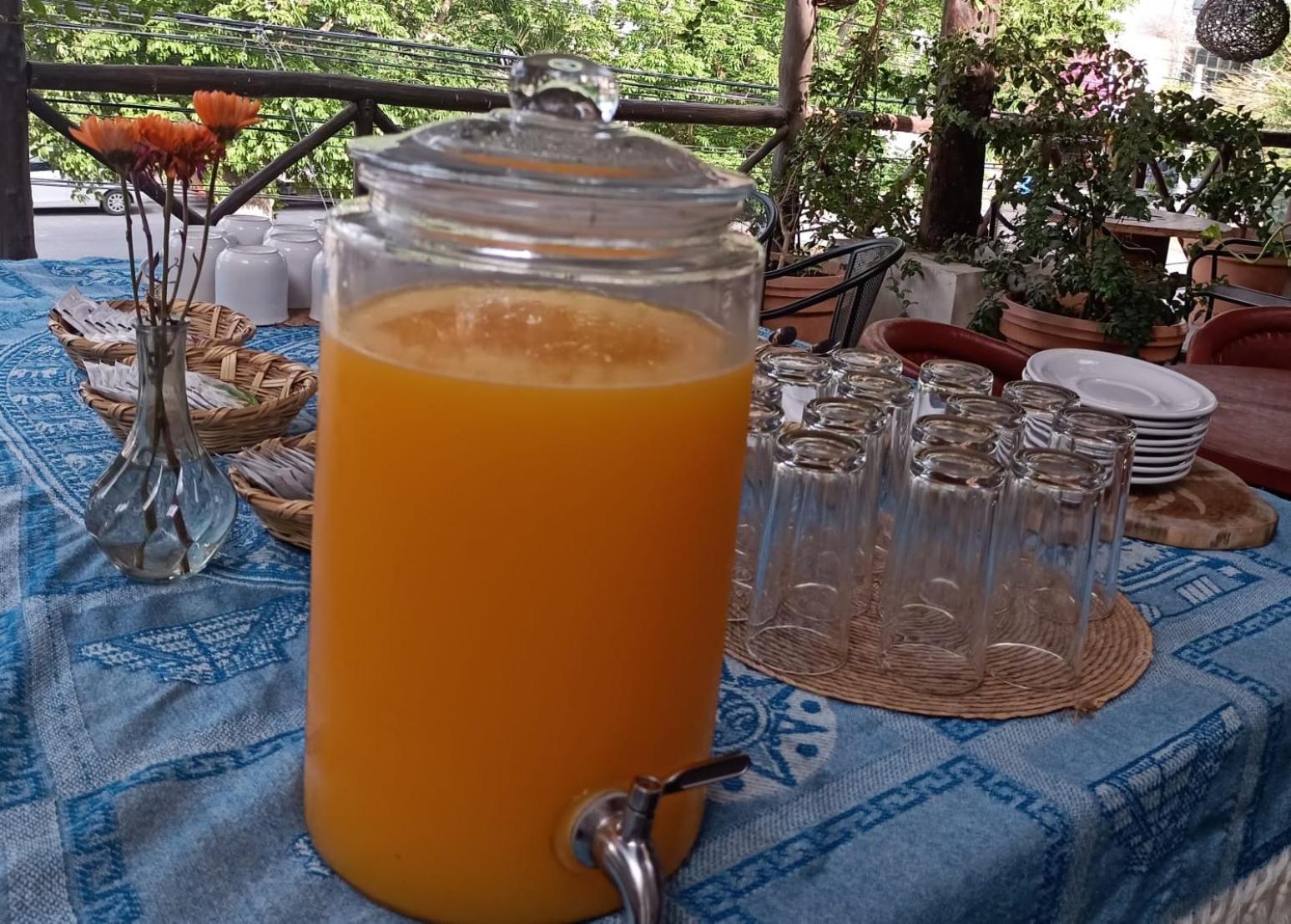 Mio Tulum Hotel Boutique Exterior photo A glass dispenser of freshly squeezed orange juice